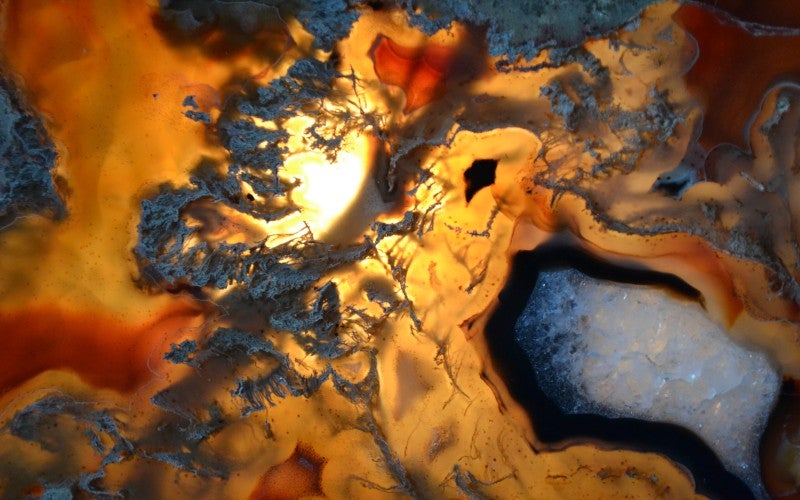 A yellow, blue, and white thunder egg rock slab.
