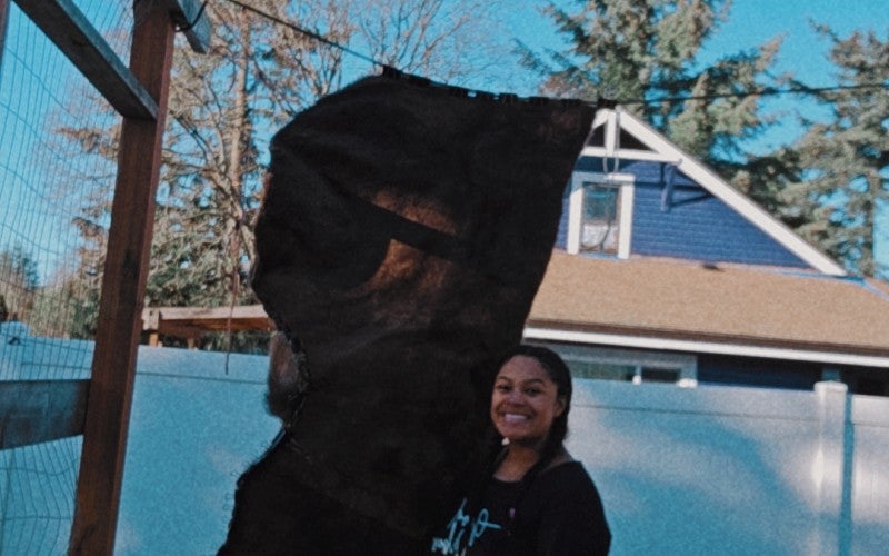 Eleeziaa stands next to a landmark