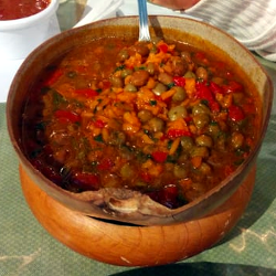 Asopao de Gandules, or green pigeon peas and rice soup, served in a wooden bowl.