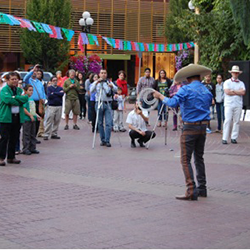 Jose demonstrates cowboy rope work in front of a crowd.