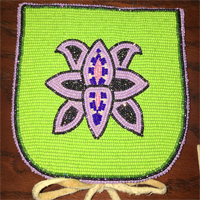Pouch with green beaded background and beaded purple flower design in the center.