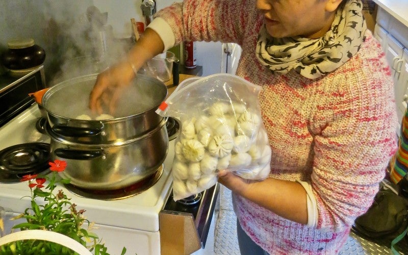 Ang Diki Sherpa in the process of cooking the momo dumplings