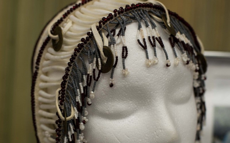 A white and brown beaded hair piece.