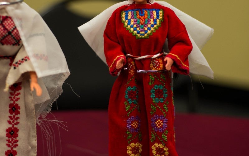 A doll wearing a red embroidered robe