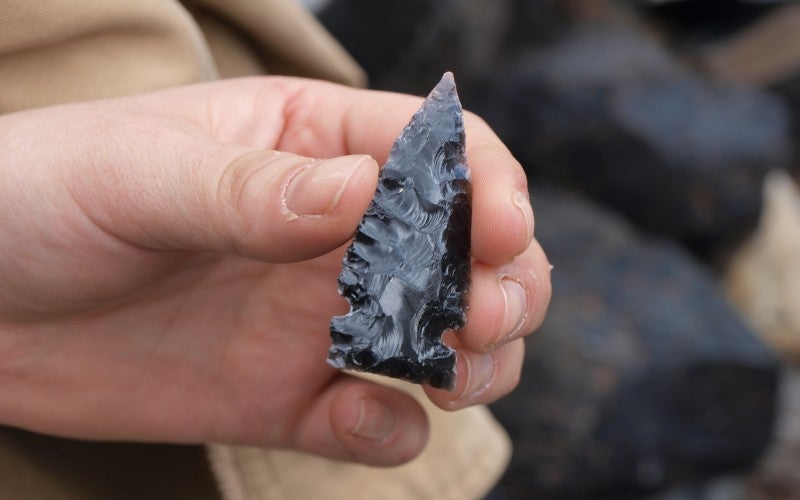 An arrowhead made from black obsidian.