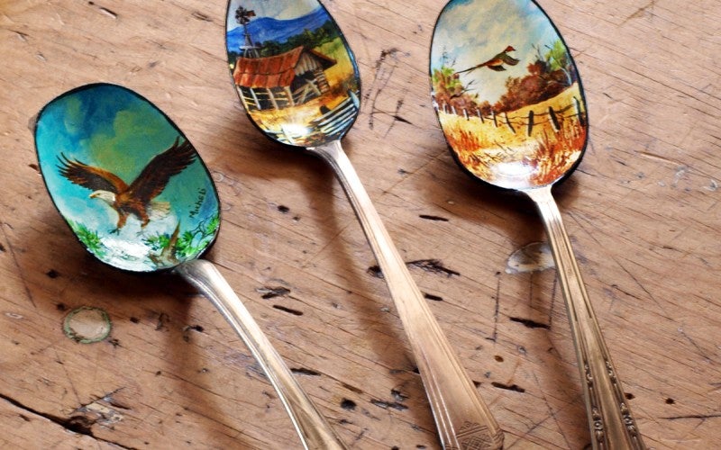 Silver spoons with birds painted on them