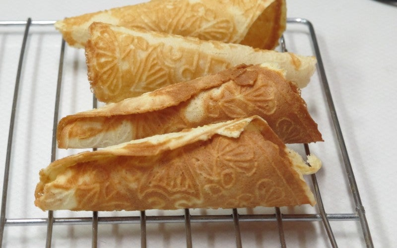 Four piece of lefse sit on a cooling rack.