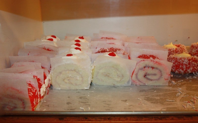 Close-up picture of cake-roll slices in a display case.