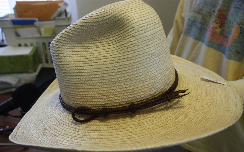 A tan cowboy hat with a brown string.