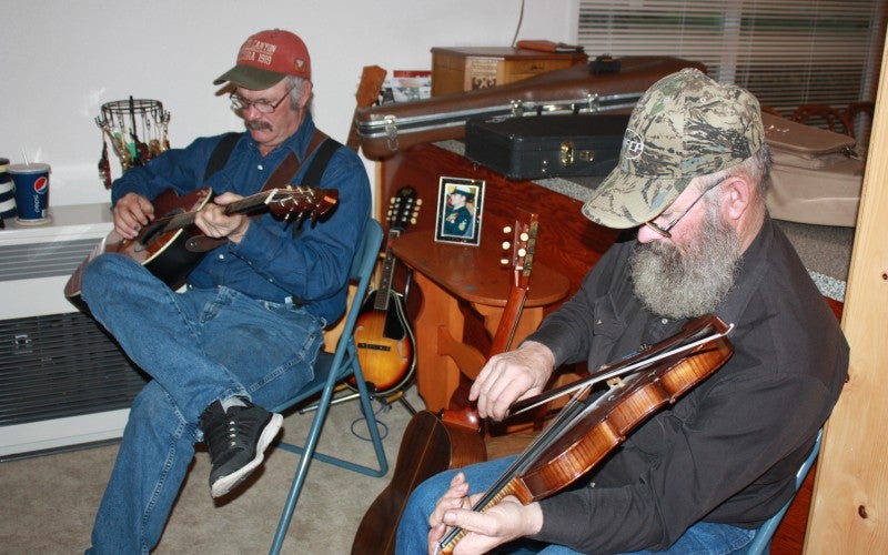 Larry plays a fiddle.