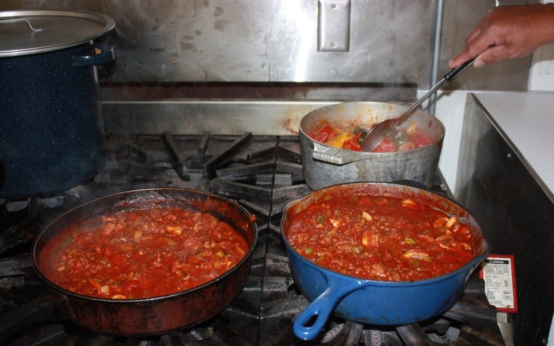 Two traditional italian dishes on the stove