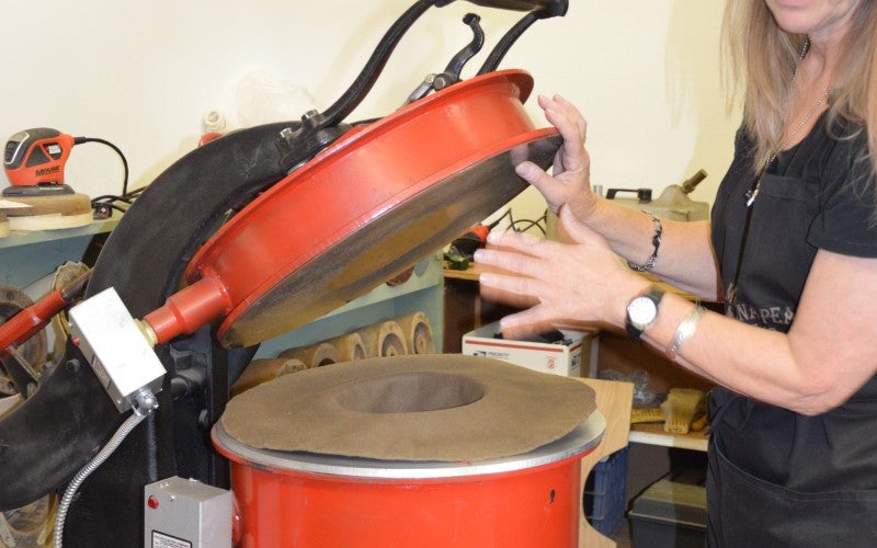 A circular red machine for making hats.