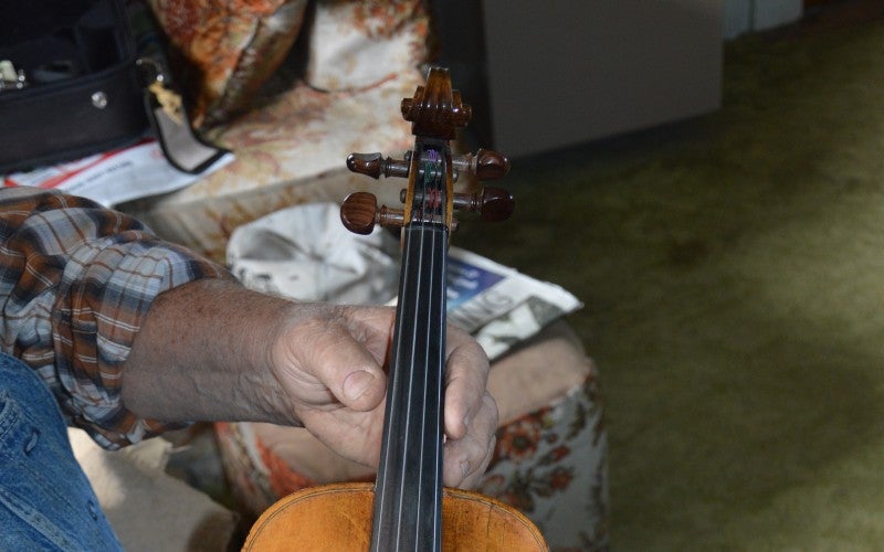 Robert holds a violin