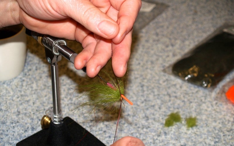 John makes a green fly fish hook on a special tool.