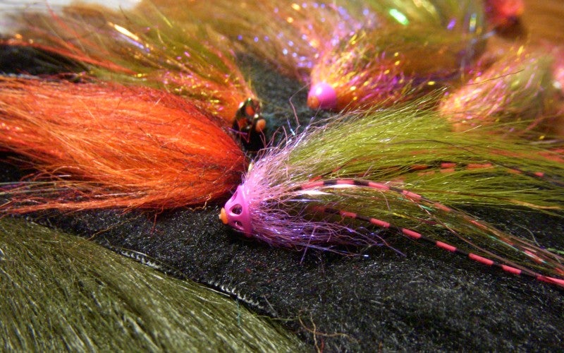 Multi-colored fly fish hooks.
