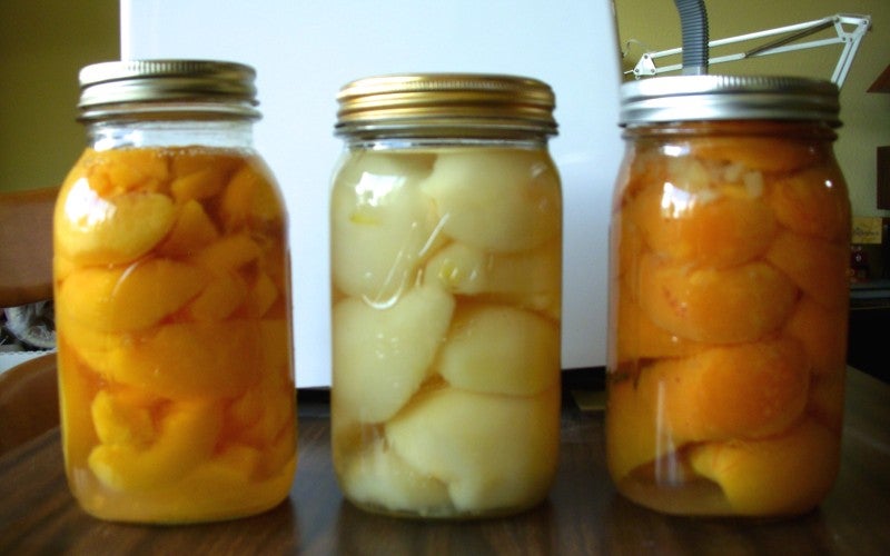 Three jars of canned fruit.