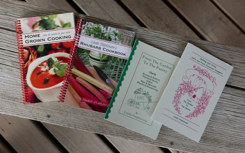 Three cookbooks on a bench written by Linda Stephenson.