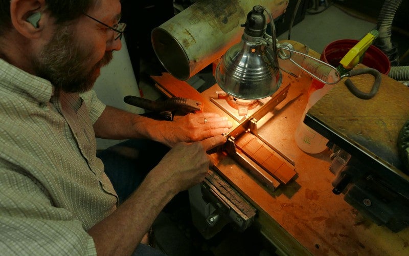 Steve Campbell works at a workbench
