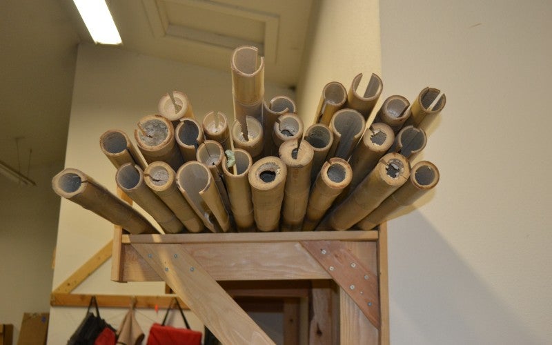 Close-up of the ends of a shelf of bamboo in artists workshop.