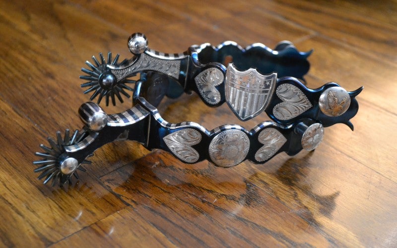 A pair of silver boot spurs.