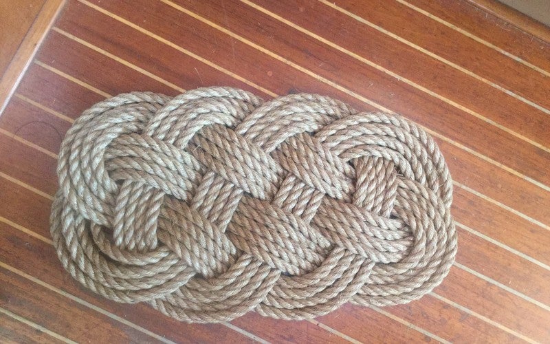 A light gray knotted rope mat.