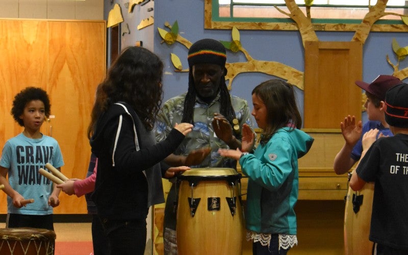 Yingwana Khosa drums with five children