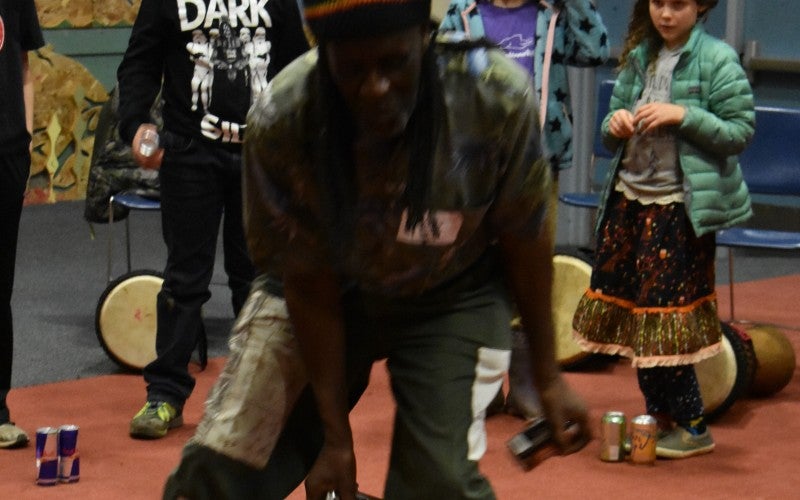 Yingwana Khosa dances with two soda cans