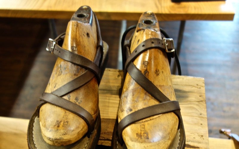 A pair of dark brown leather sandals.