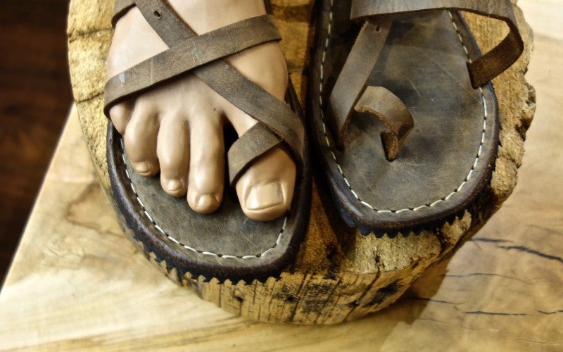 A pair of dark brown leather sandals.