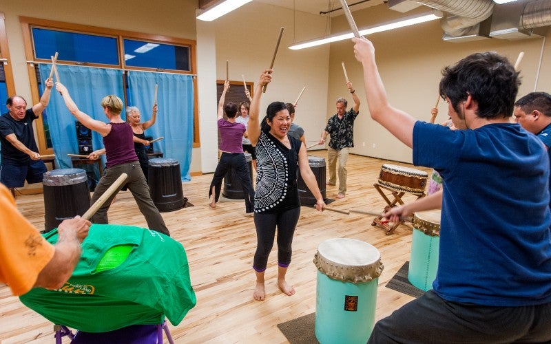 Michelle Fujii instructs people in a taiko workshop
