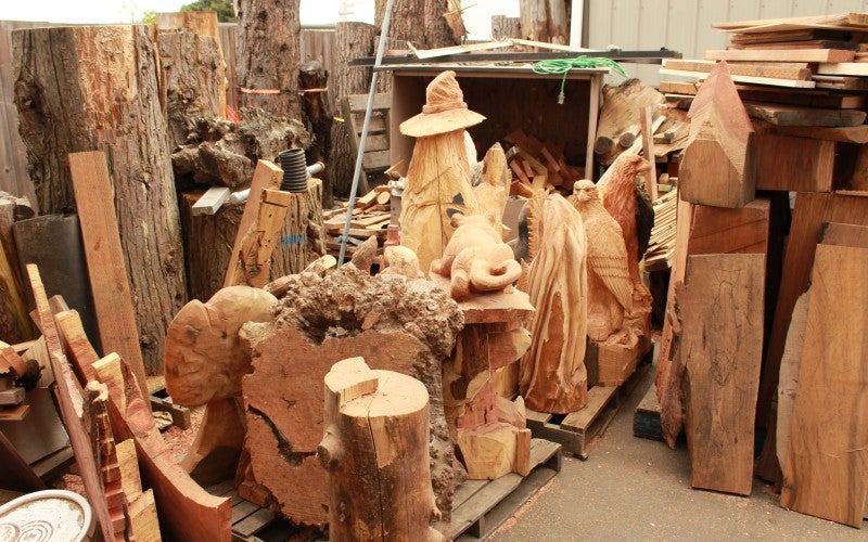 Various wood carvings and logs of wood.