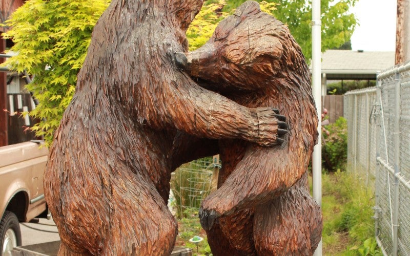 A wood carving of two fighting bears.