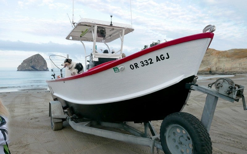 A red, white, and black boat that says "OR 332 AGJ"