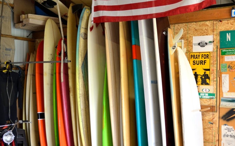 Surfboard stored upright in Brad's workshop.