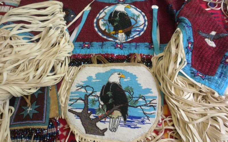 Traditional dress regalia containing eagle imagery.