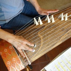 Someone plays a Japanese koto