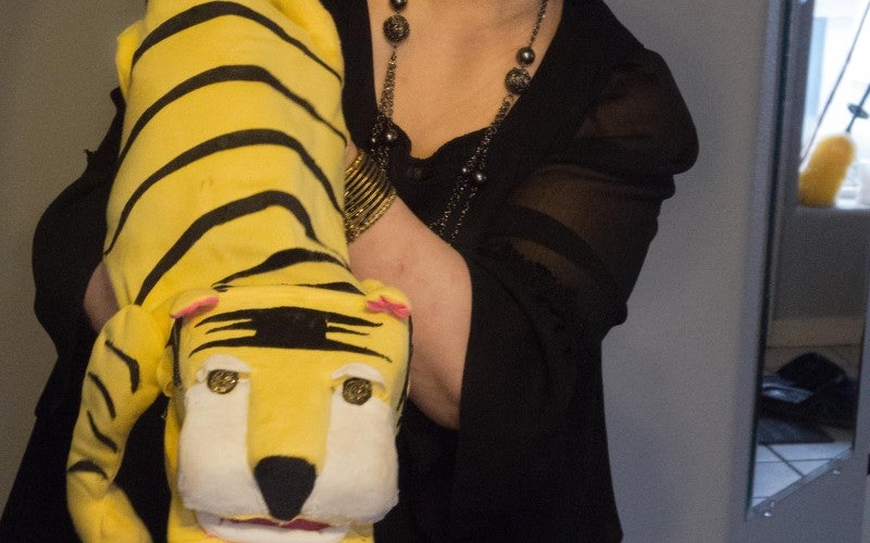 Yuqin Wang displays a tiger puppet