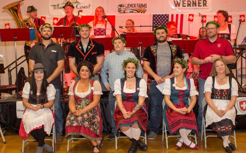 Members of the Tillamook Swiss Society await the results of the Schwingfest Crowning Ceremony. Image by Greg Kozawa, for the Tillamook Coast Visitor's Association.