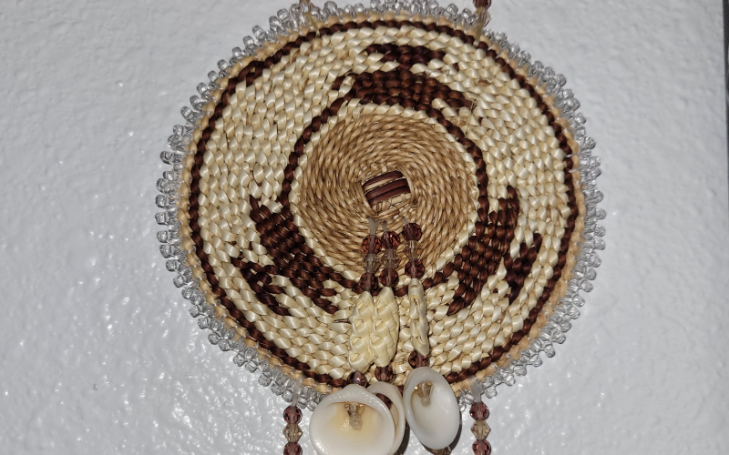 A woven piece by Beth'Ann, complete with beads and shells.