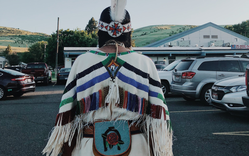 A Buckskin Dress, containing a beaded "deer tail" triangle (signifying the tail of a deer). 