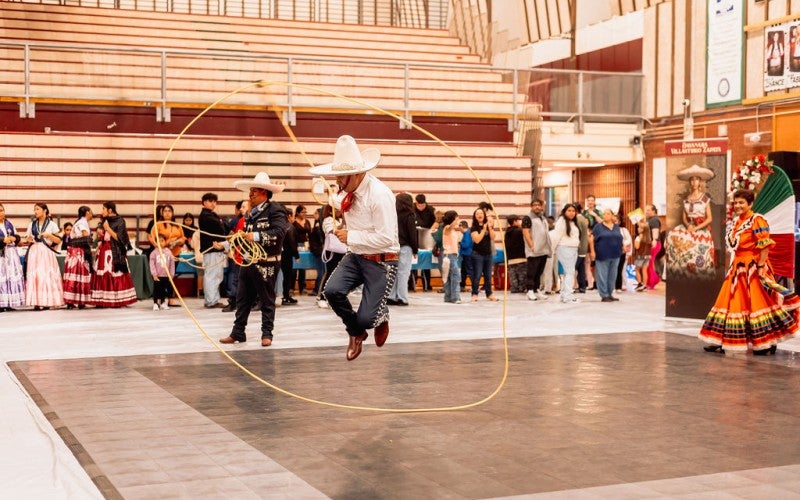 Antonio jumps through a rope circle at an assembly.