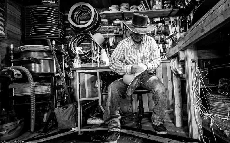 Lisa Robinson in her studio shaping a hat