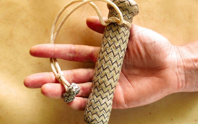 Terri holds a rawhide braided rod