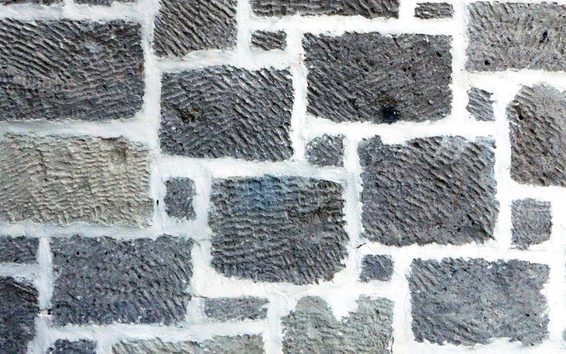 A gray and white cobblestone-style wall.