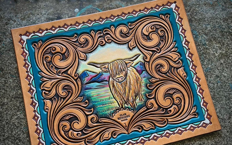 Brown leather piece with intricate details, and a oxen in a landscape of the plains.