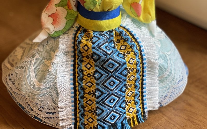 One of Shatalova's dolls, featuring the blue and yellow of Ukraine's flag.
