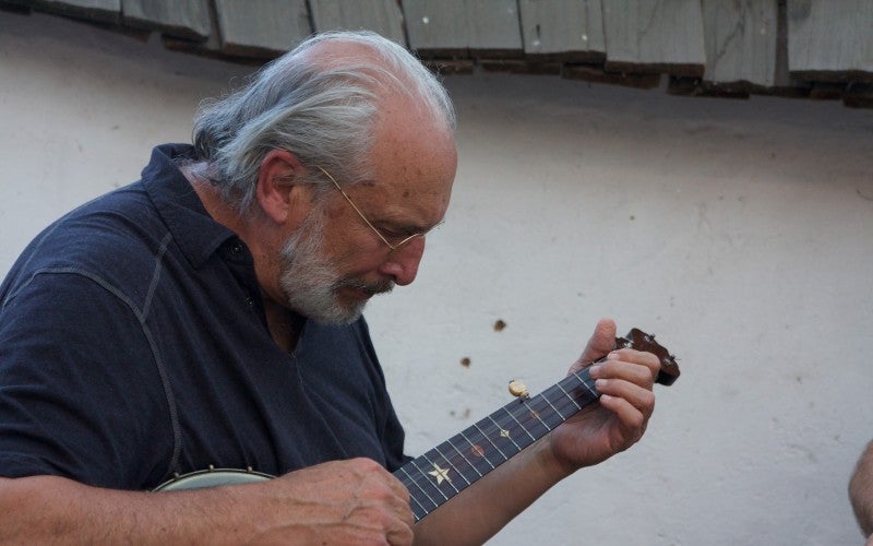 Close up of John Meade playing the banjo