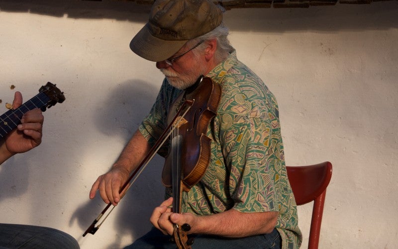 Close up of Joe Huff playing the fiddle