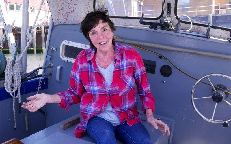 Terri Stone talking while sitting in a boat