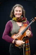 Woman holding a fiddle.
